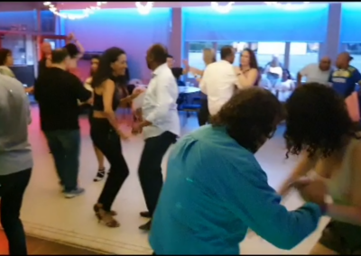 Dancers in elegant attire performing salsa and bachata at a dance event in Richmond, London.